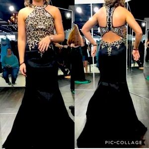 Black halter neck, open back, mermaid style dress.